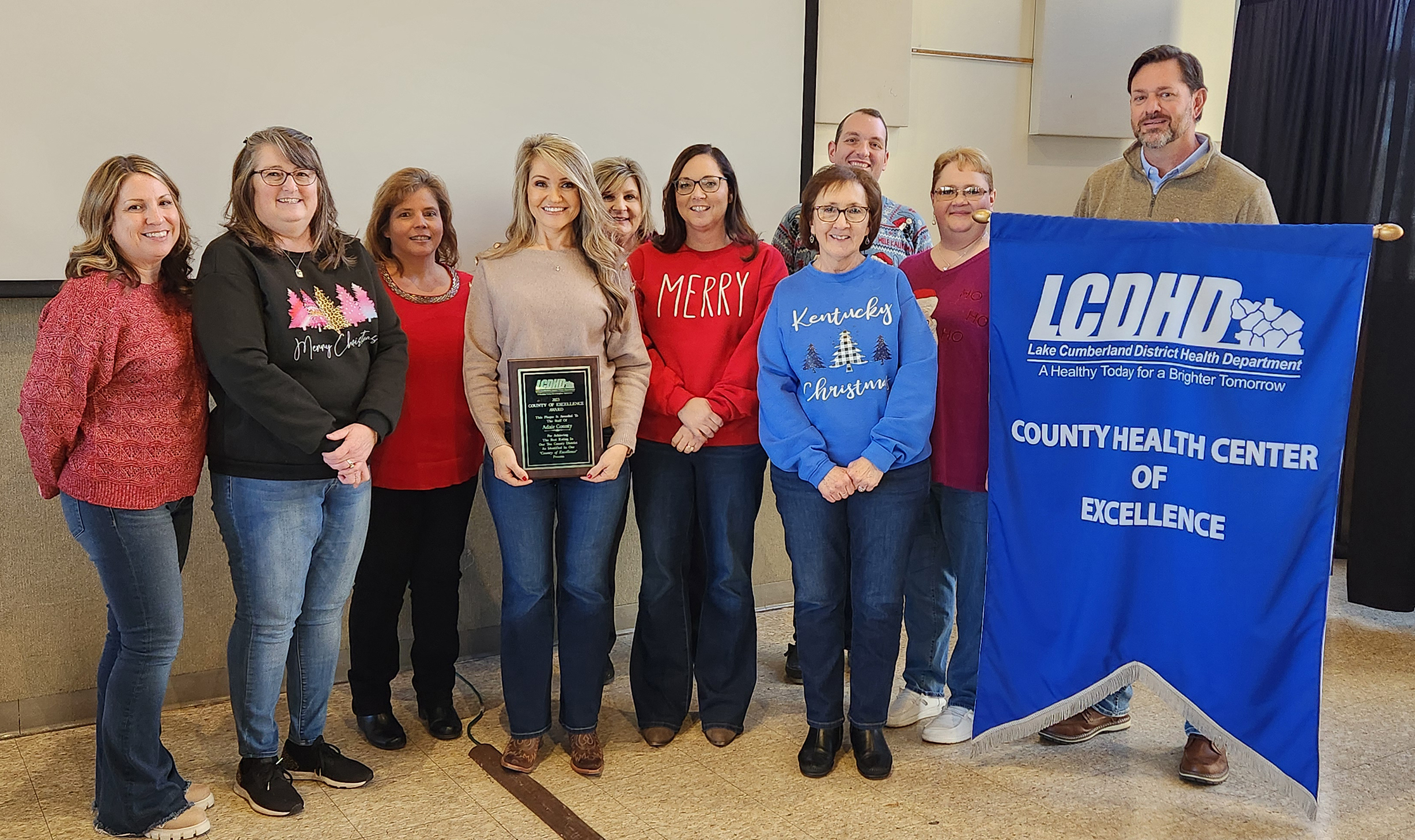 The Adair County Health Department staff received their plaque and County Health Center of Excellence banner after being ranked the top health department in the Lake Cumberland District.